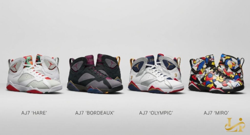 Four Air Jordan 7 pairs — Hare, Bordeaux, Olympic, and a multicolor art-inspired version — lined up on white. Each shoe is labeled beneath, showing evolution from classic to contemporary designs.