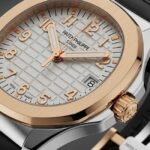 A detailed, angled close-up photograph of a Patek Philippe Aquanaut watch. The timepiece features a two-tone case of polished rose gold and what appears to be steel.