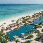 An expansive aerial view of a luxurious adults-only resort with a long, elegant swimming pool complex running parallel to a pristine white-sand beach and the turquoise Caribbean Sea, typifying the romantic setting of a top-tier Secrets Resorts property.